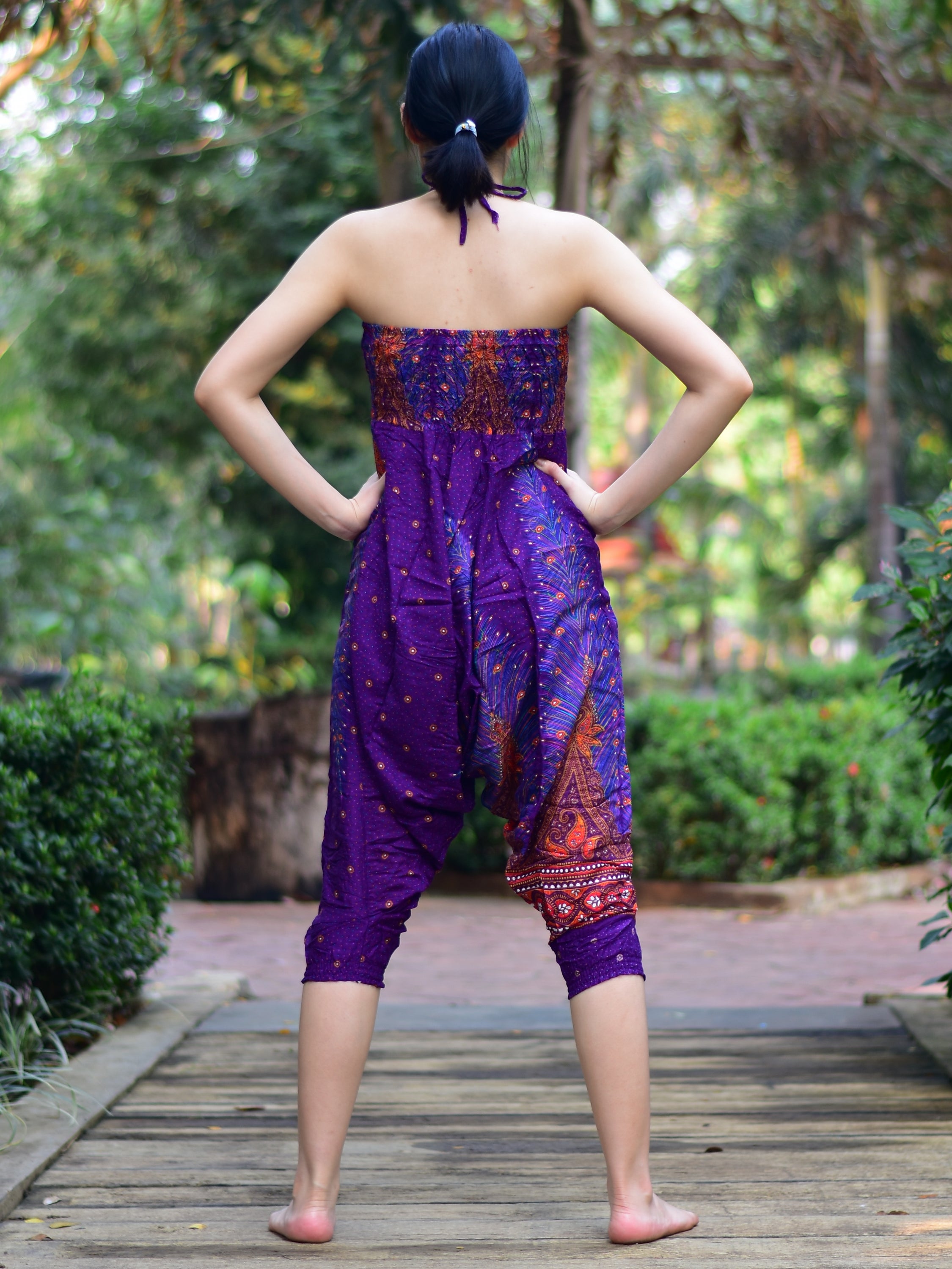 Bohotusk Purple Peacock Print Jumpsuit showcasing vibrant colors and unique design, perfect for versatile styling.